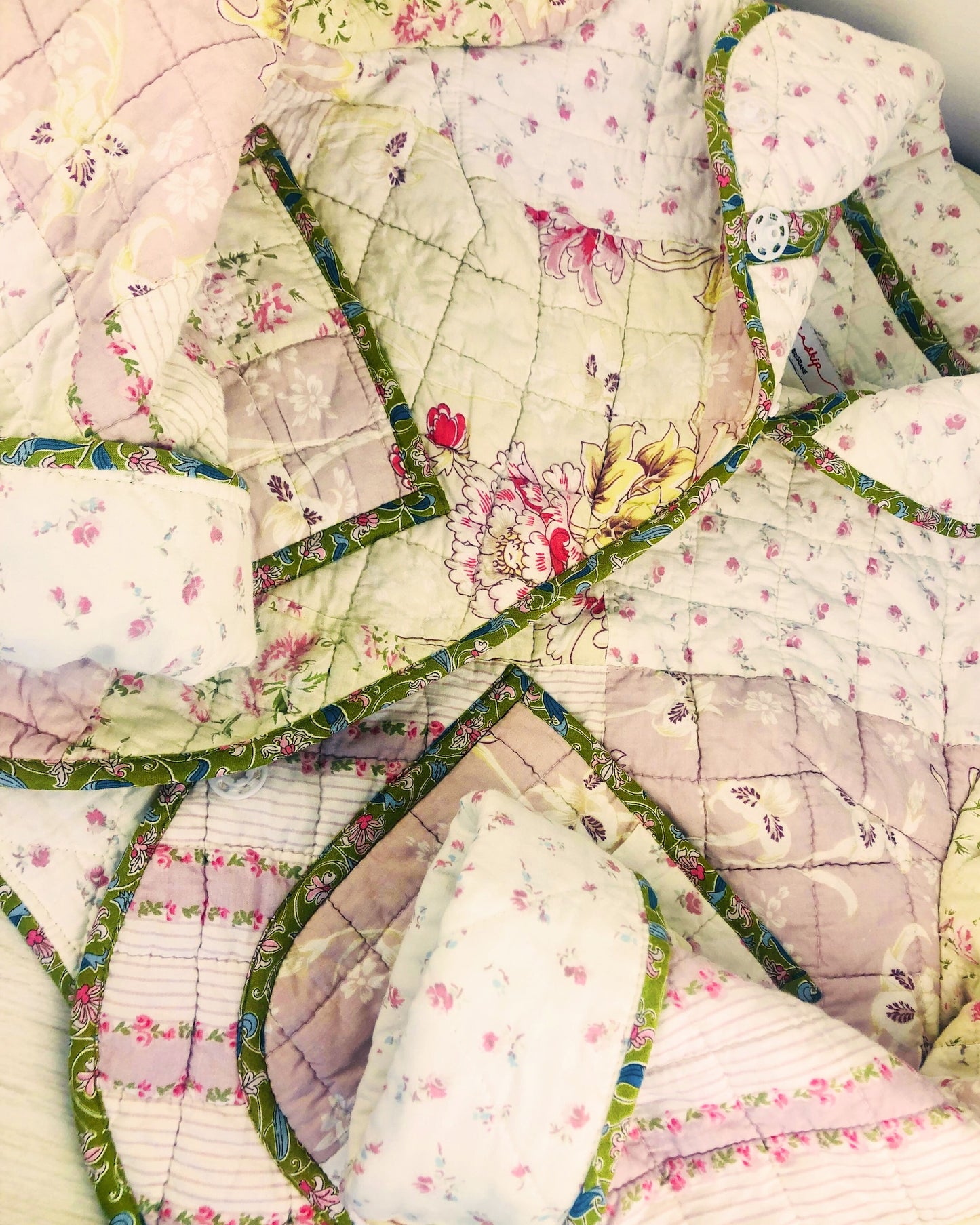 Quilted jacket made in Brisbane with floral patterns and green borders on a light background