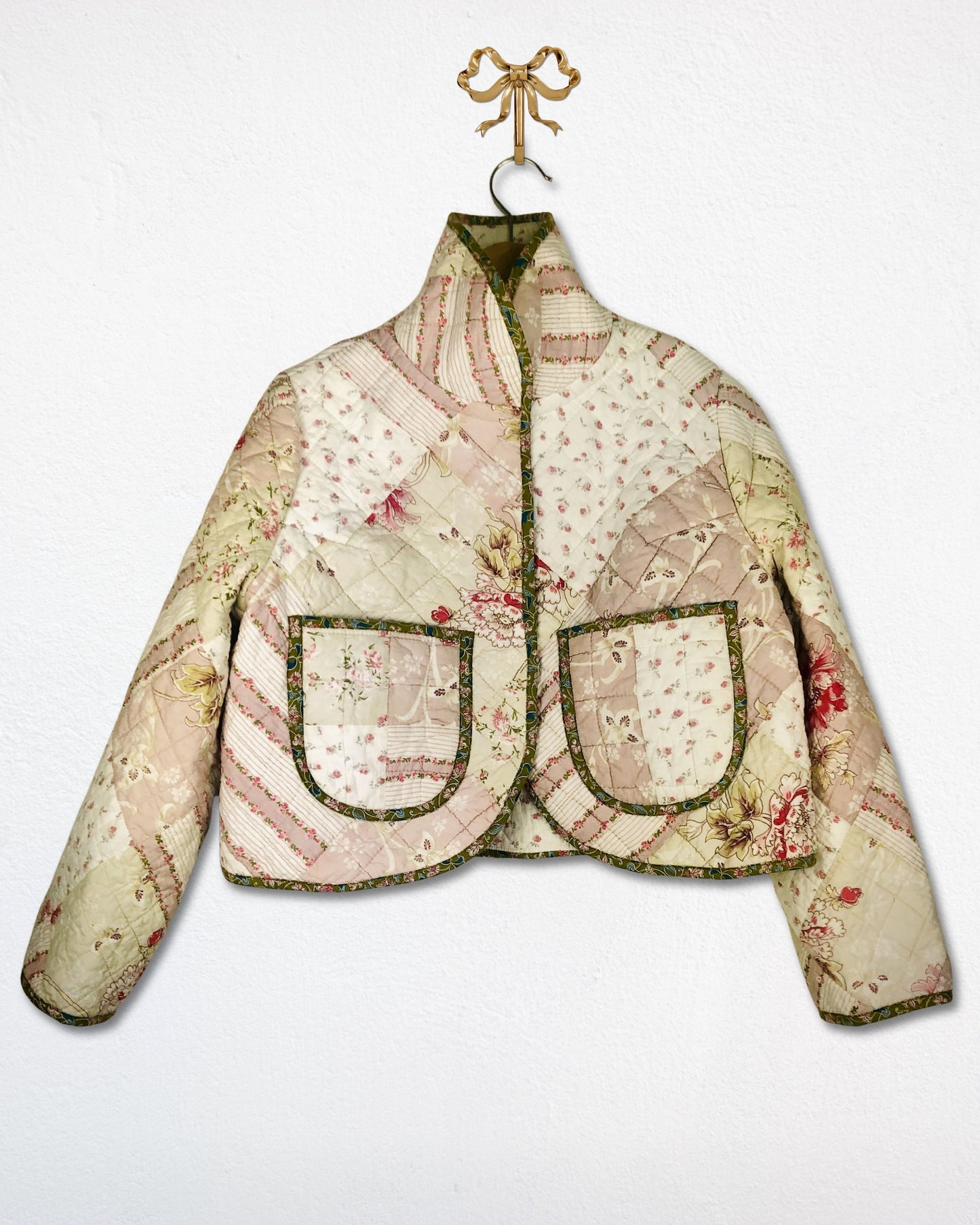 Floral quilted jacket with patch pockets on a white background