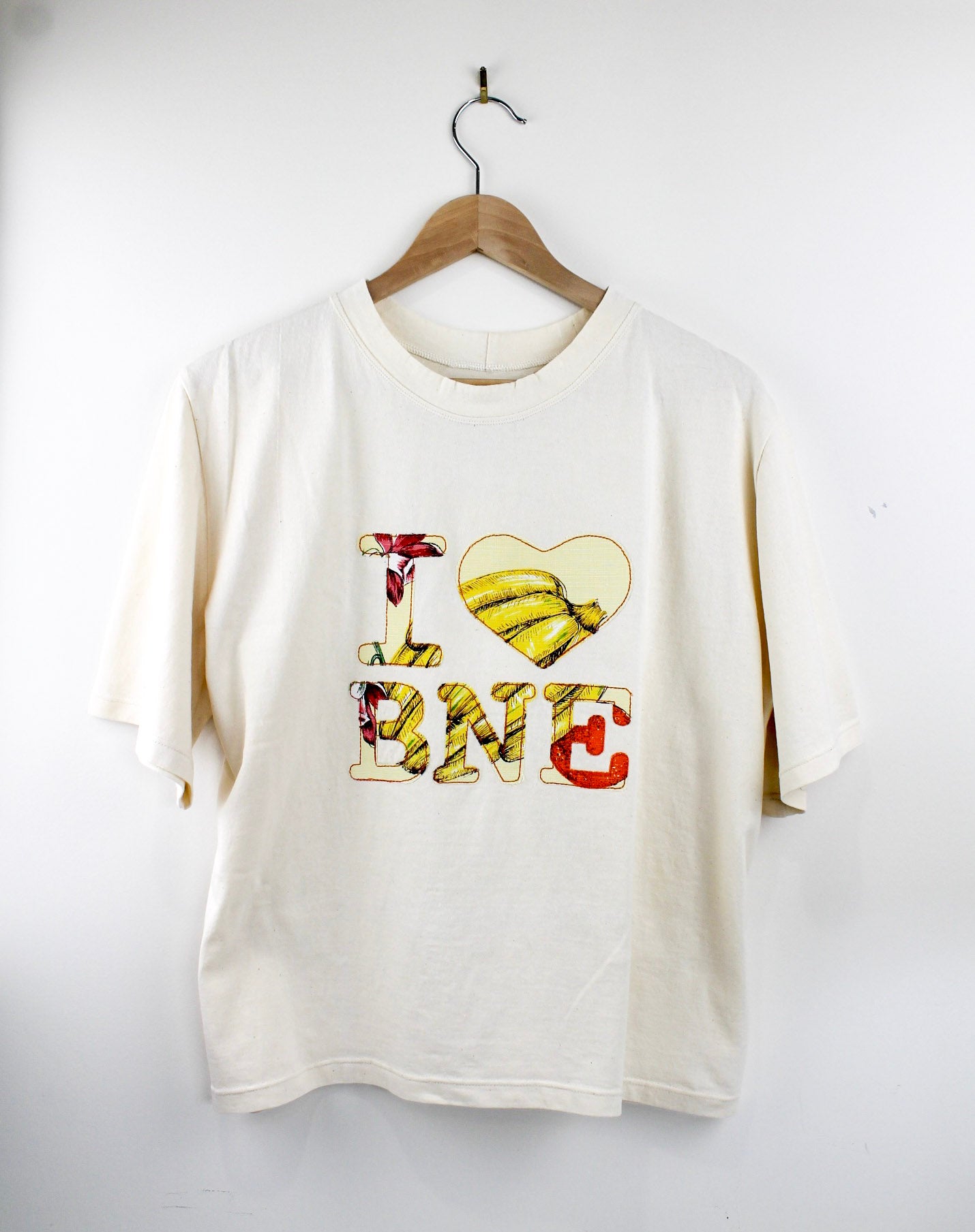 White t-shirt with colorful graphic design on a white background