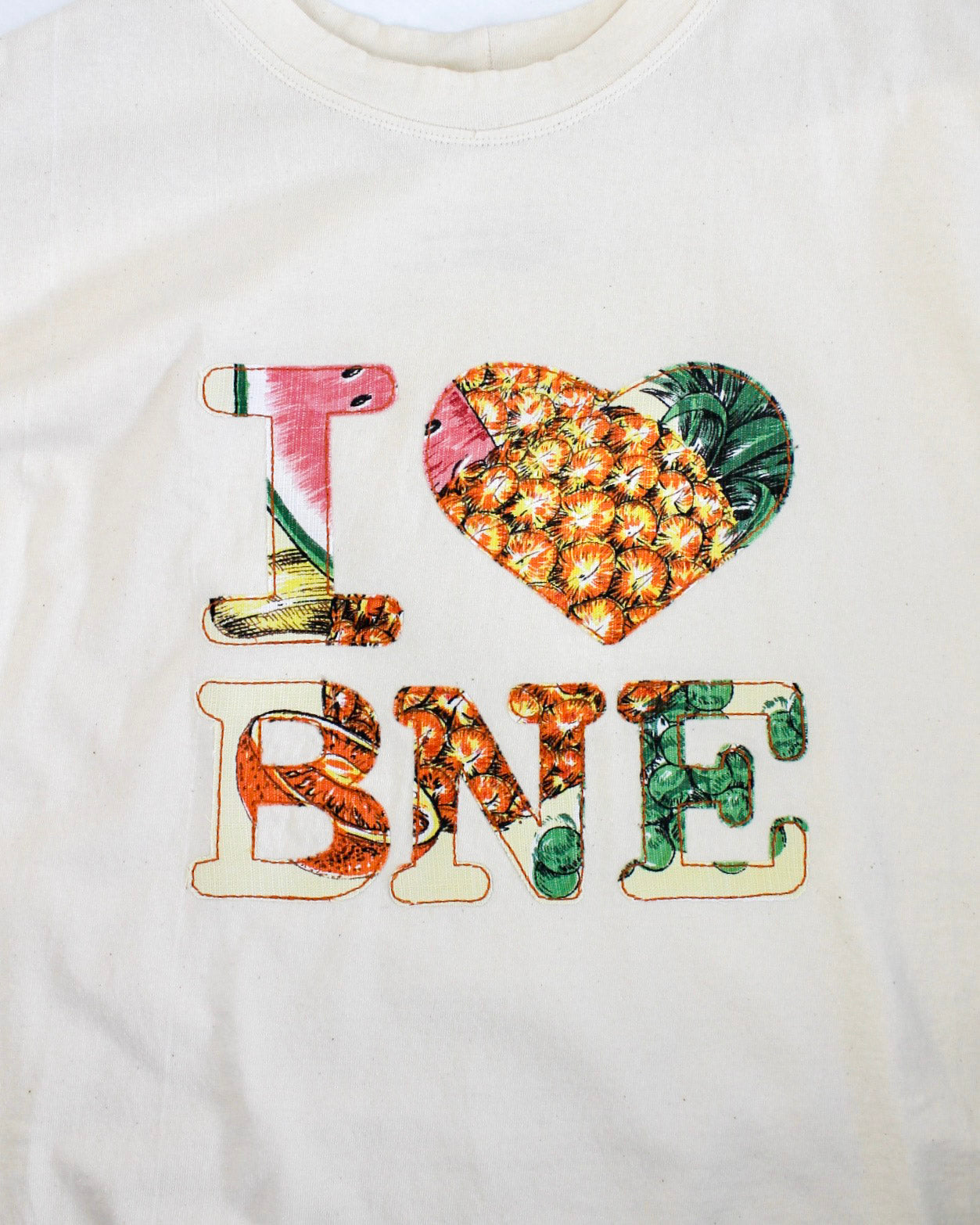 White sweatshirt with colorful 'I ❤️ BNE' design on a white background