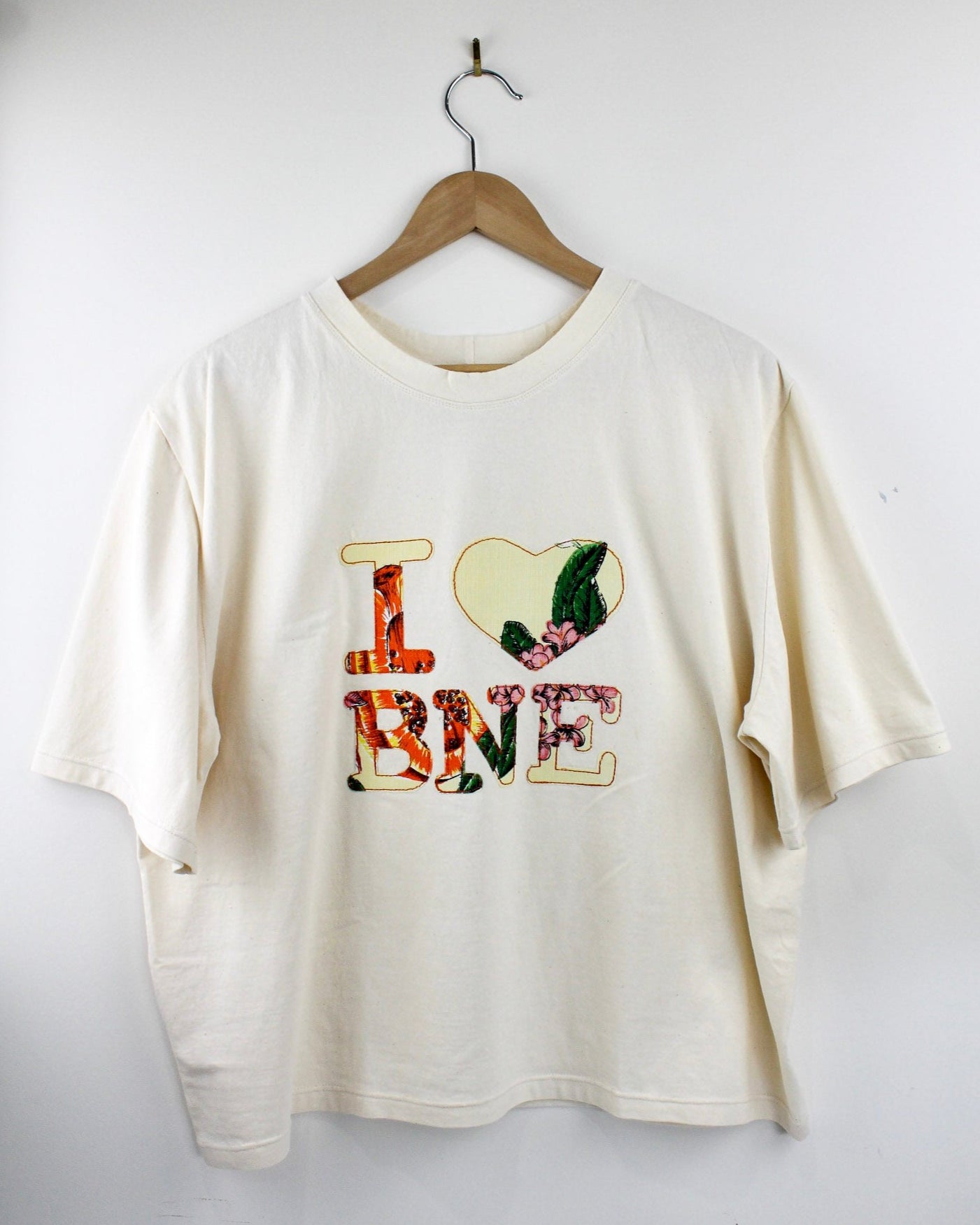 White sweatshirt with colorful text and design on a white background