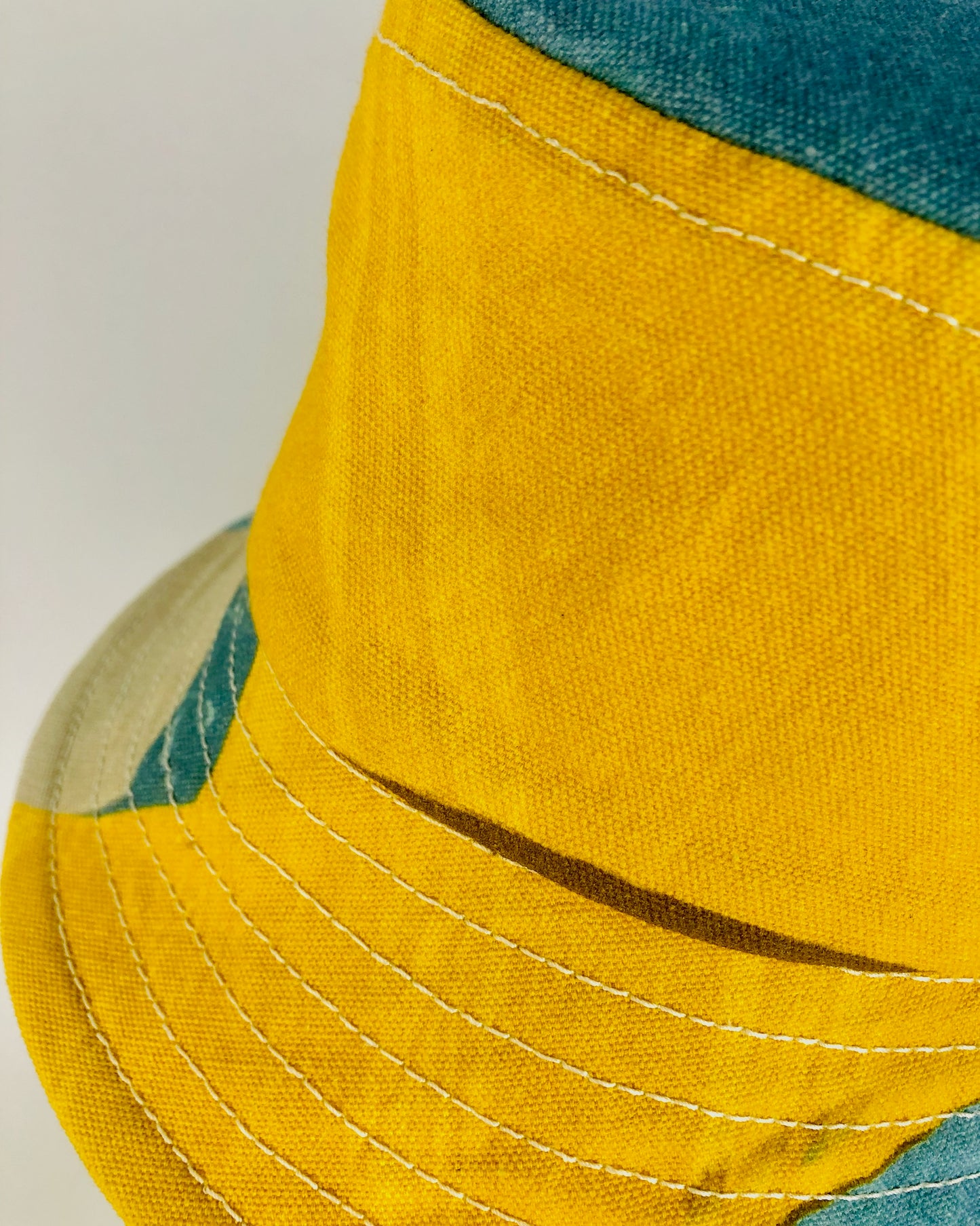 Close up detail of yellow and blue bucket hat