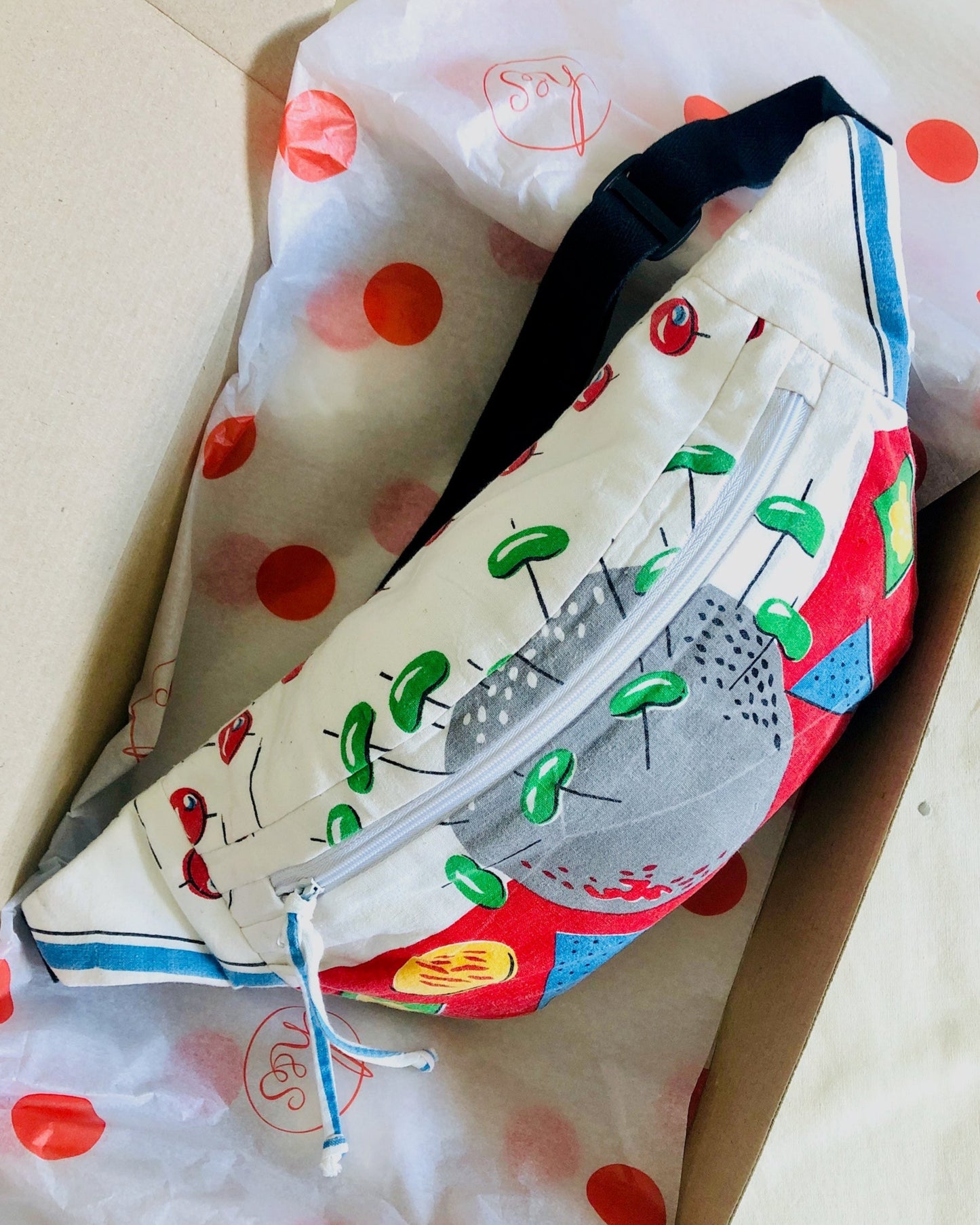 handmade bumbag packed ready for shipping in a cardboard box and branded tissue paper