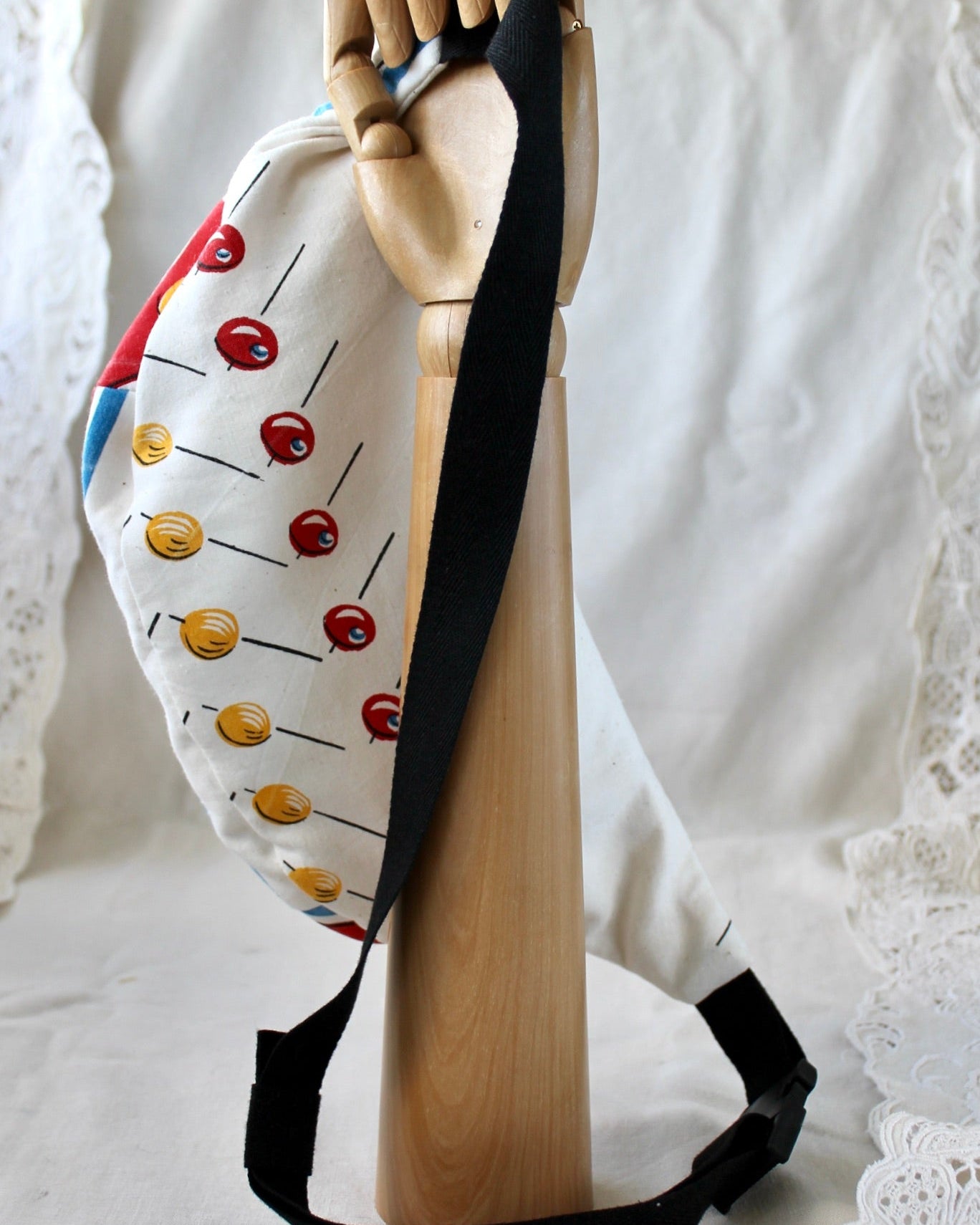 back view of bumbag made from thrifted mid century style tea towel featuring olives on toothpicks