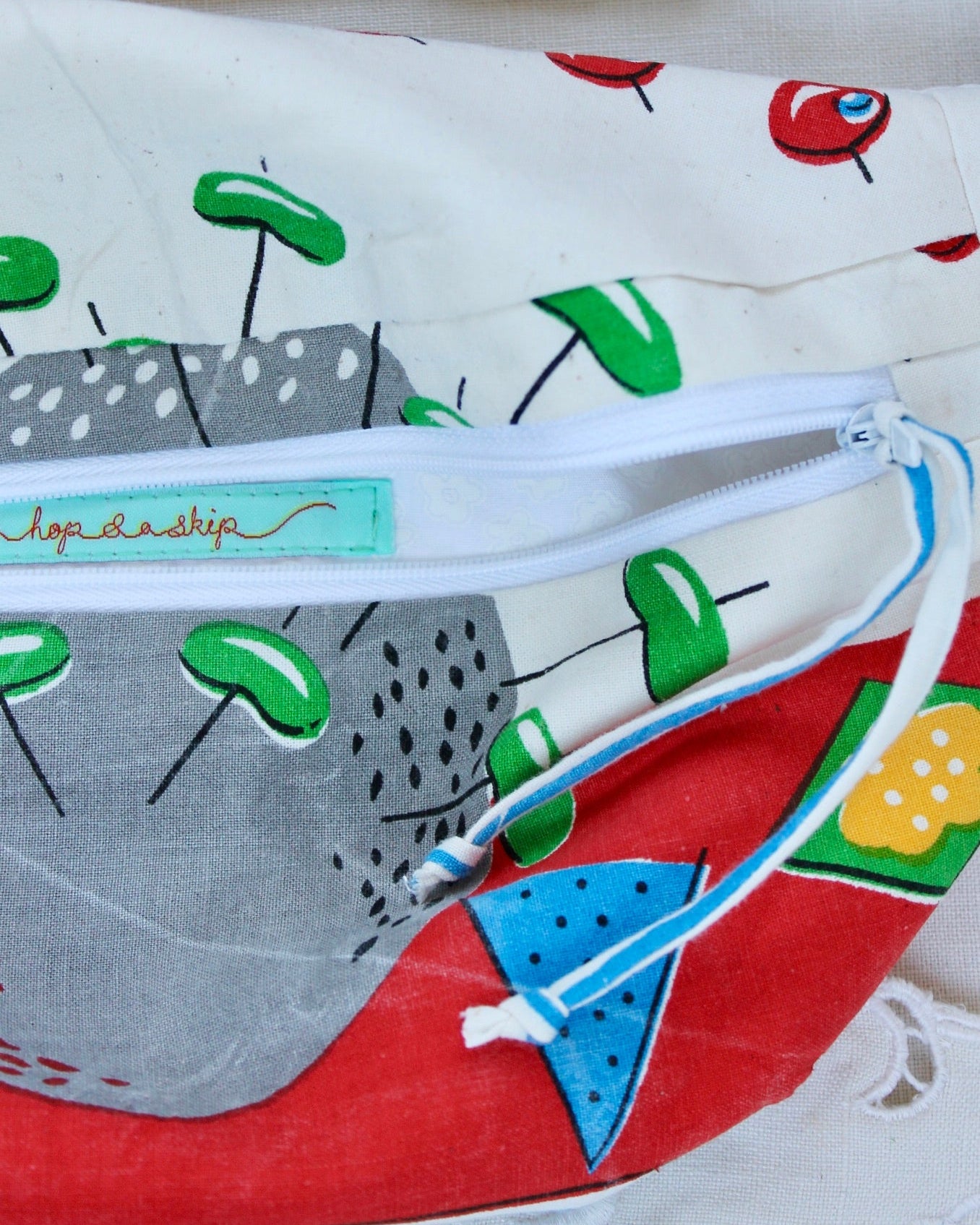 Close up detail of handmade bumbag with the zipper open and showing the fully lined inner compartment