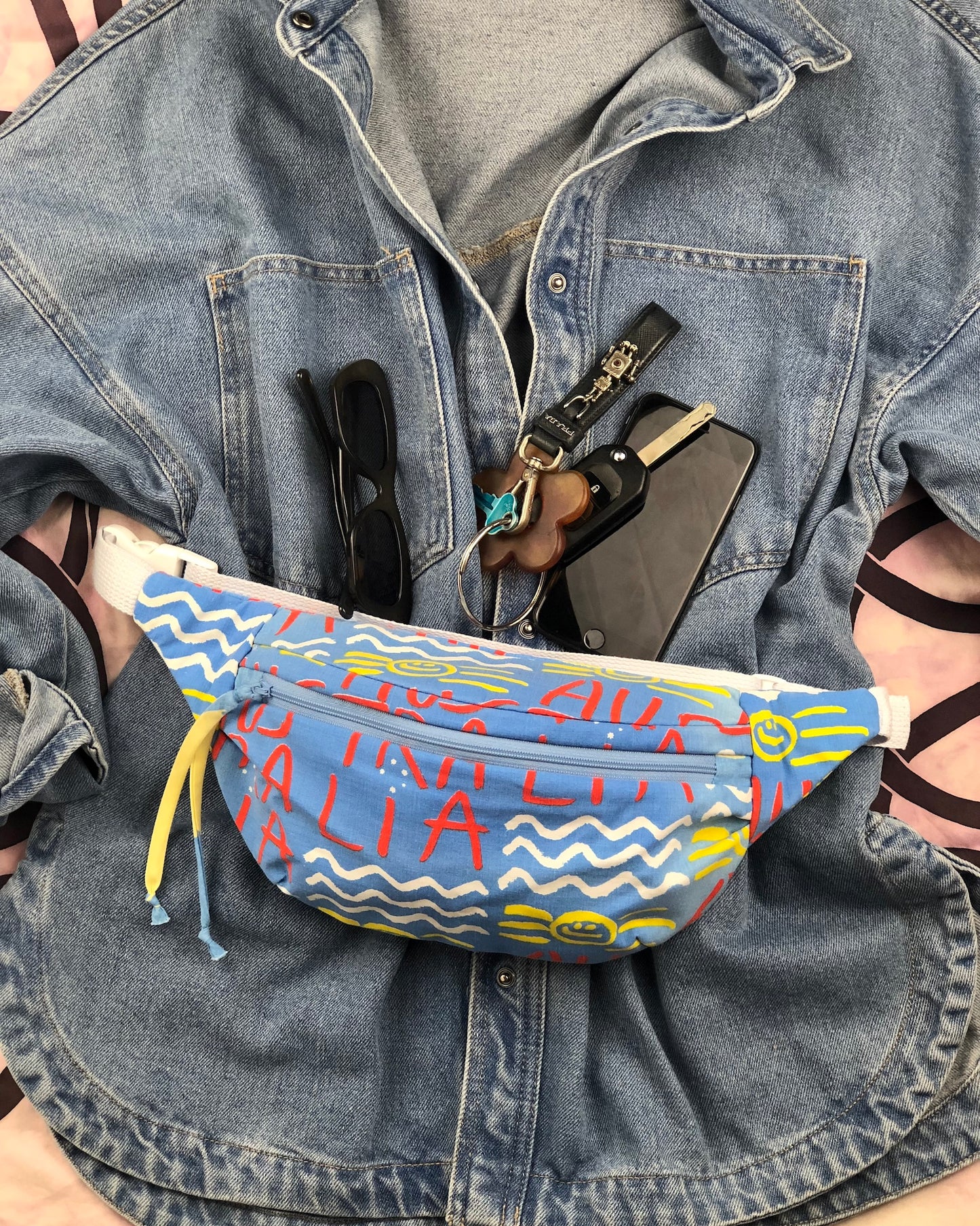 Flat lay of how to wear a bumbag made from rate ken done australia vintage bed sheets