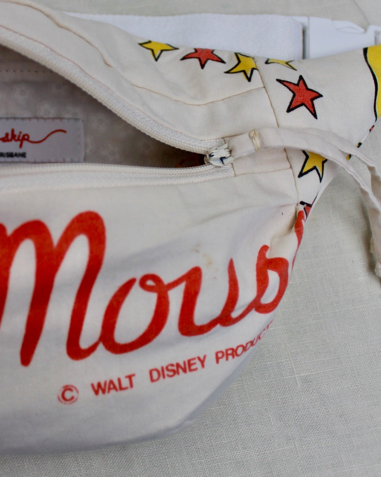 Close up detail of Mickey Mouse bumbag with the zipper open and showing the fully lined inside of the bumbag