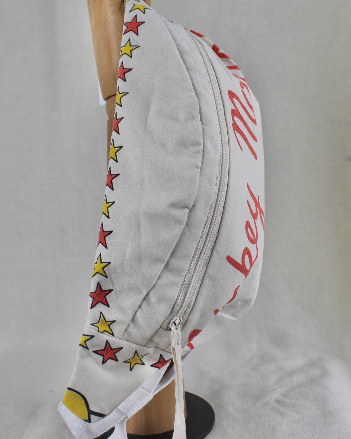 Hand made and upcycled bumbag with vintage Mickey Mouse fabric featuring red and yellow stars on a white background