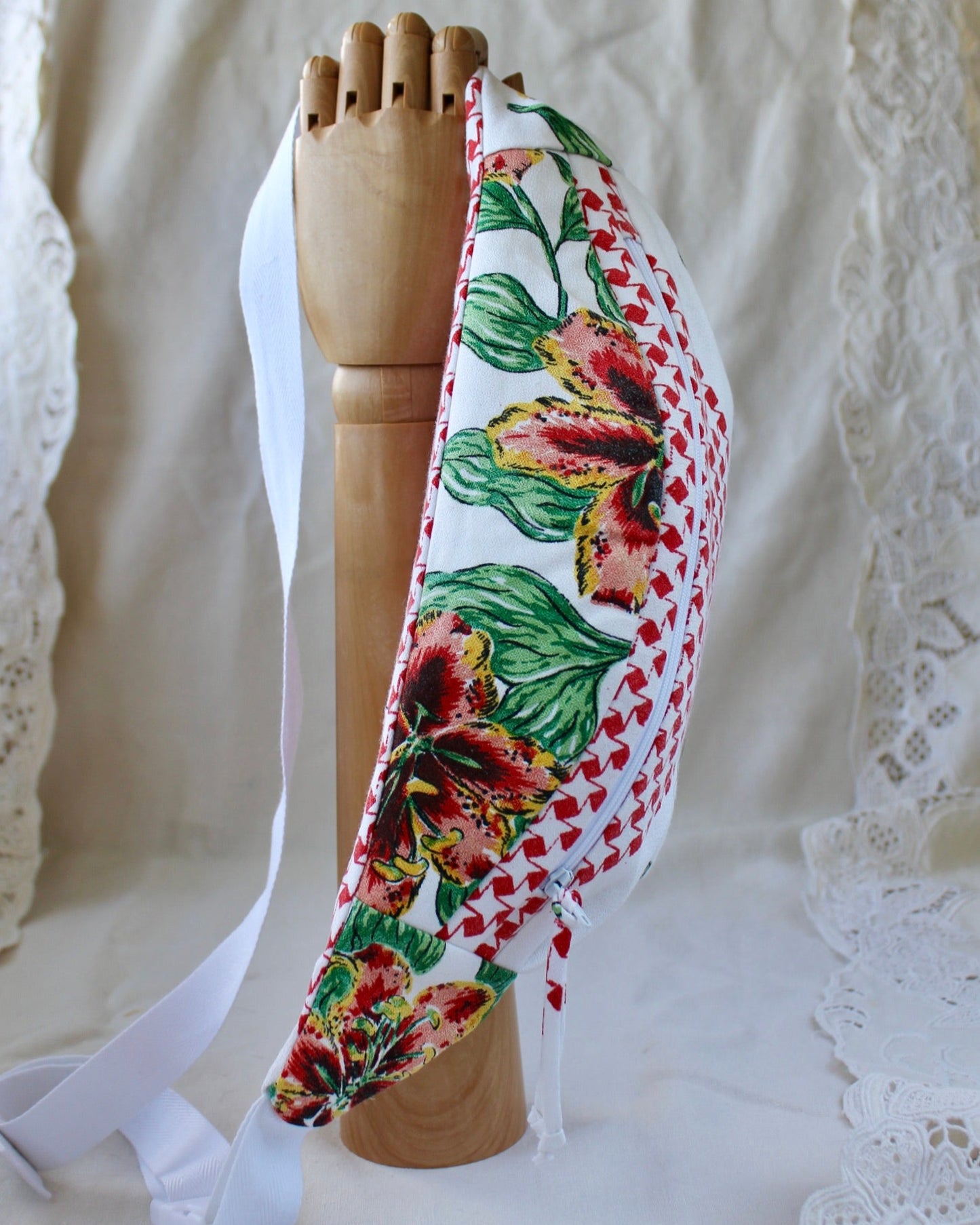 Top view of handmade fanny pack made from a thrifted vintage tablecloth featuring red and orange tiger lilies