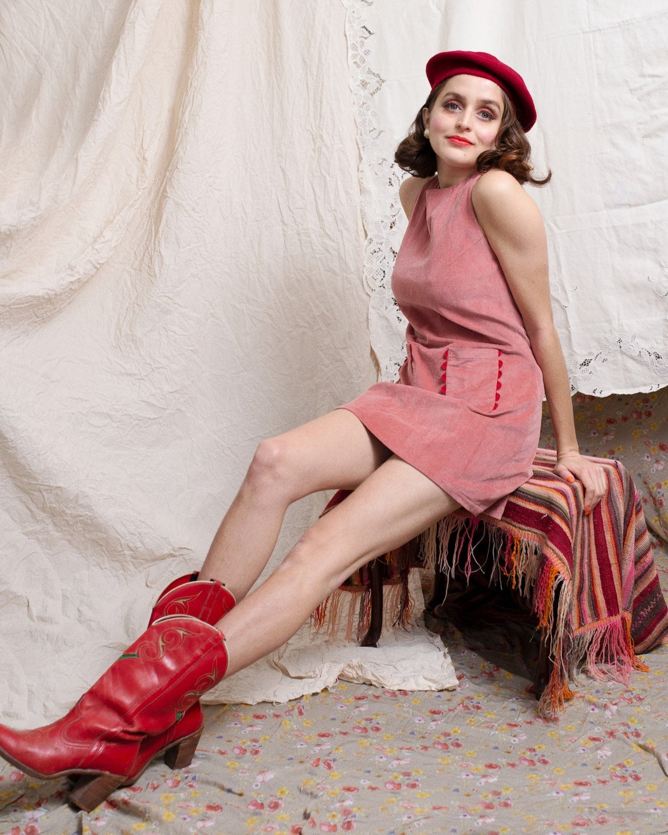 Girl wearing 60s style shift Aline dress with red beret and groovy red cowboy boots