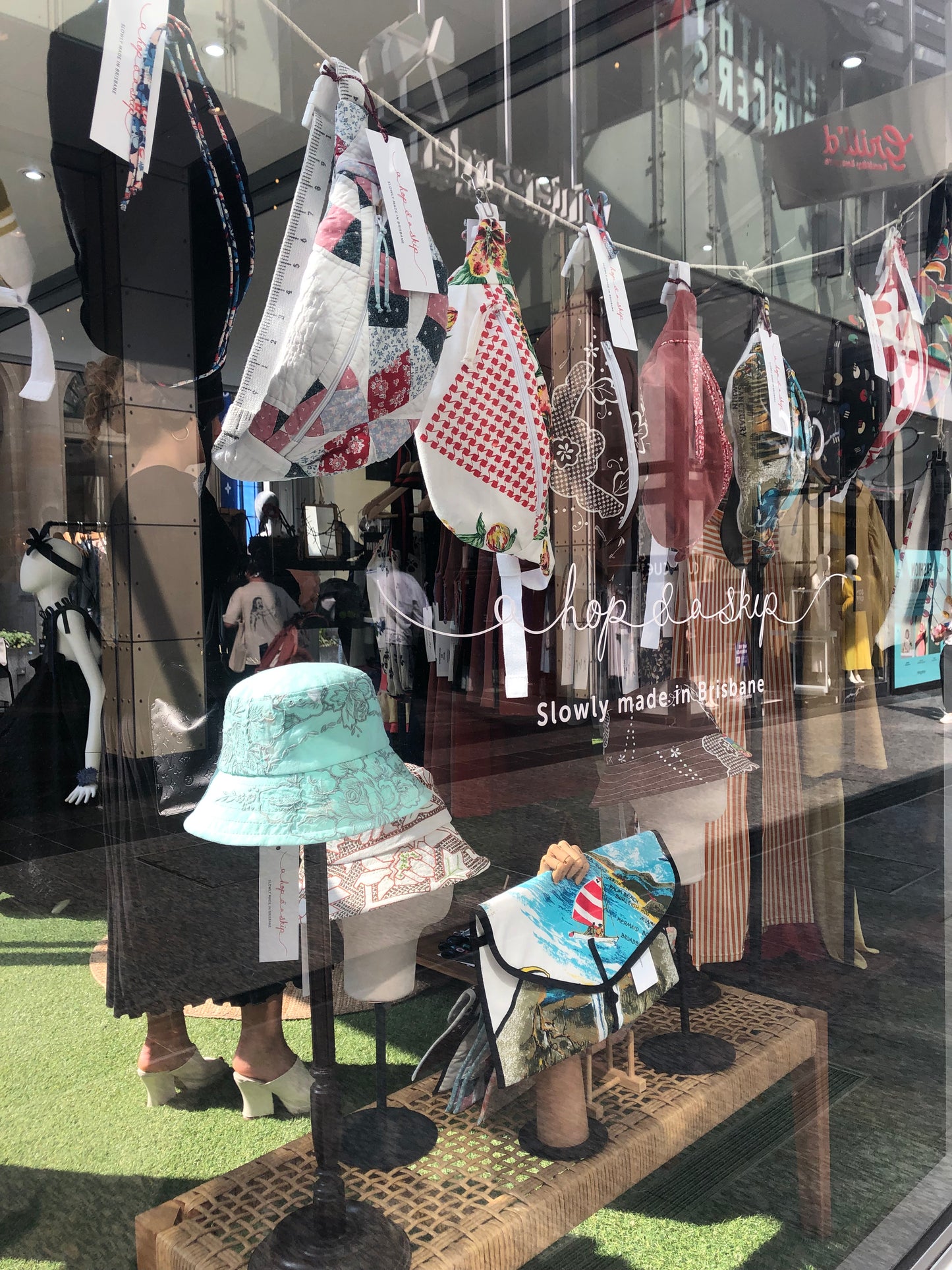 Window display of a hop and a skip pop up shop in Brisbane featuring a range of handmade and upcycled bumbags