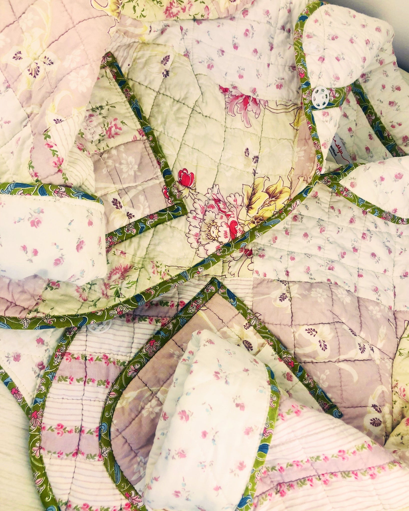 Quilted jacket made in Brisbane with floral patterns and green borders on a light background