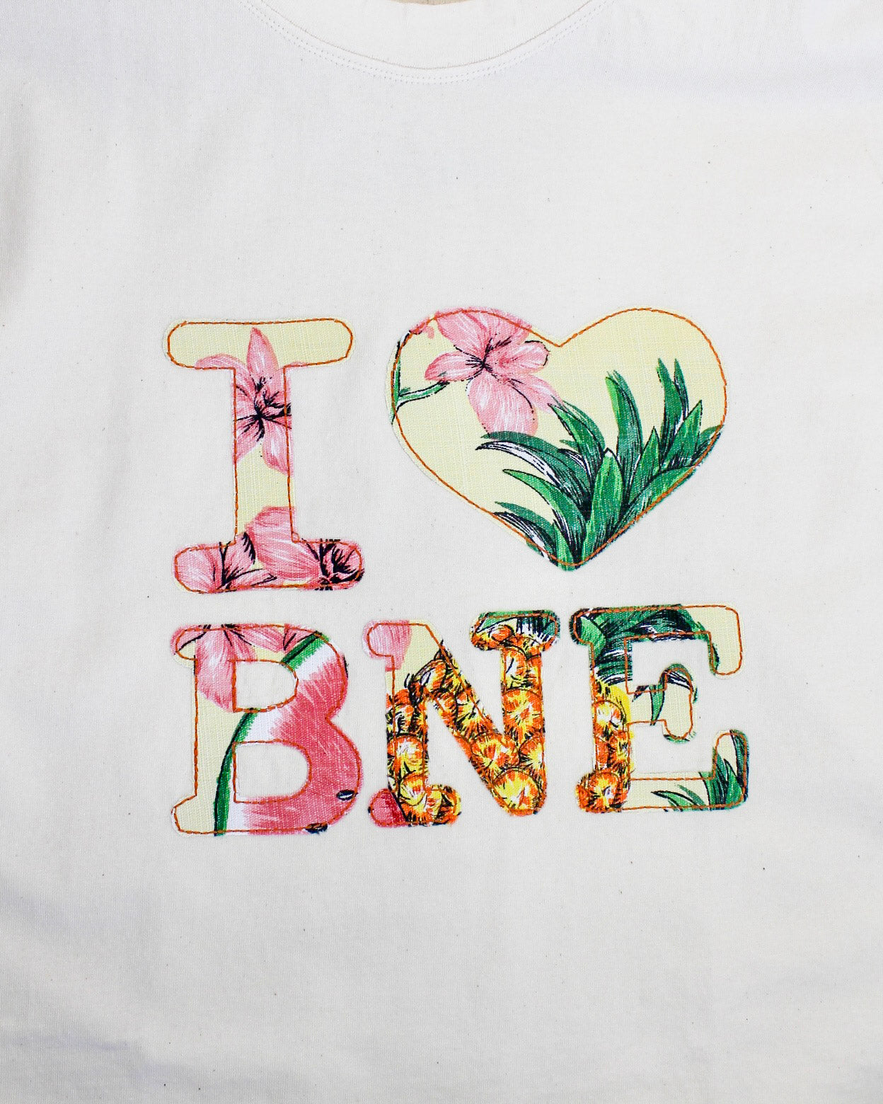 Text 'I ❤️ BNE' with floral and leaf designs on a white background