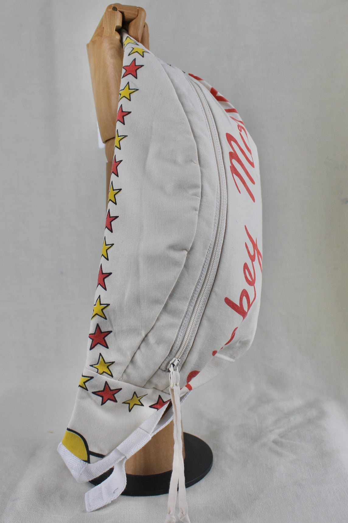 Hand made and upcycled bumbag with vintage Mickey Mouse fabric featuring red and yellow stars on a white background