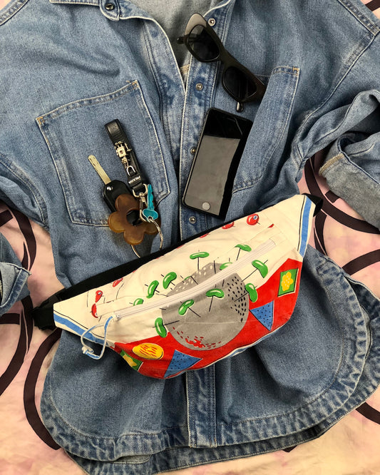 Flat lay of a bumbag made from vintage tea towel in a rare mid century print