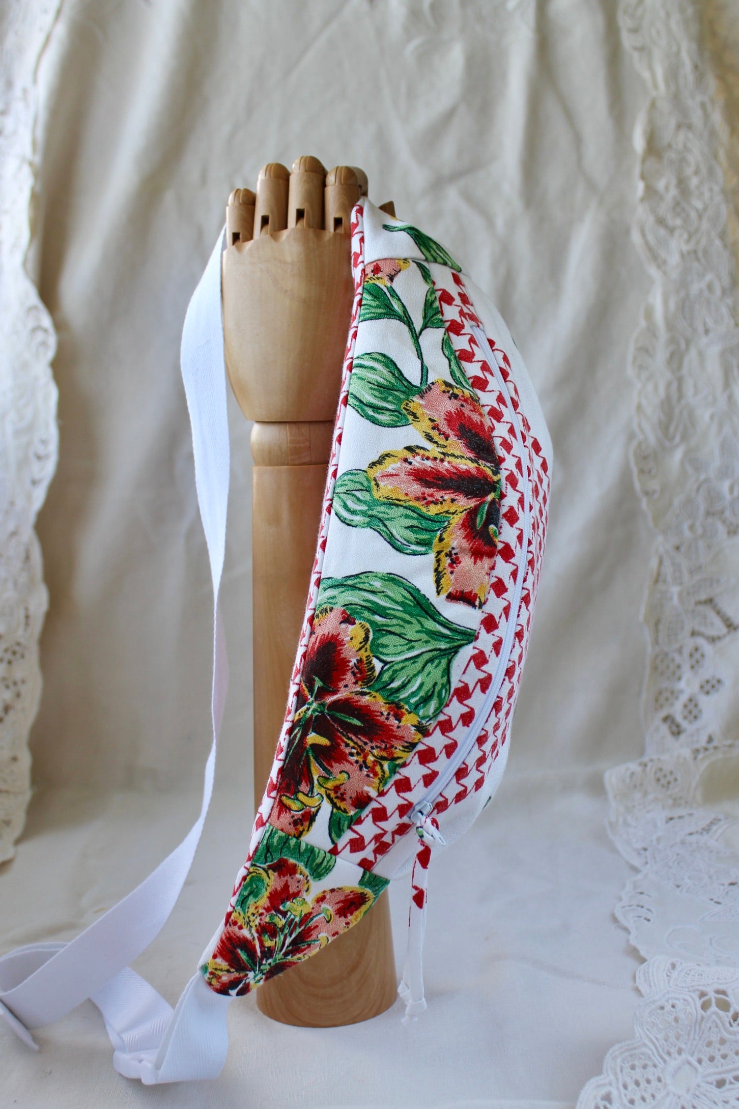 Top view of handmade fanny pack made from a thrifted vintage tablecloth featuring red and orange tiger lilies