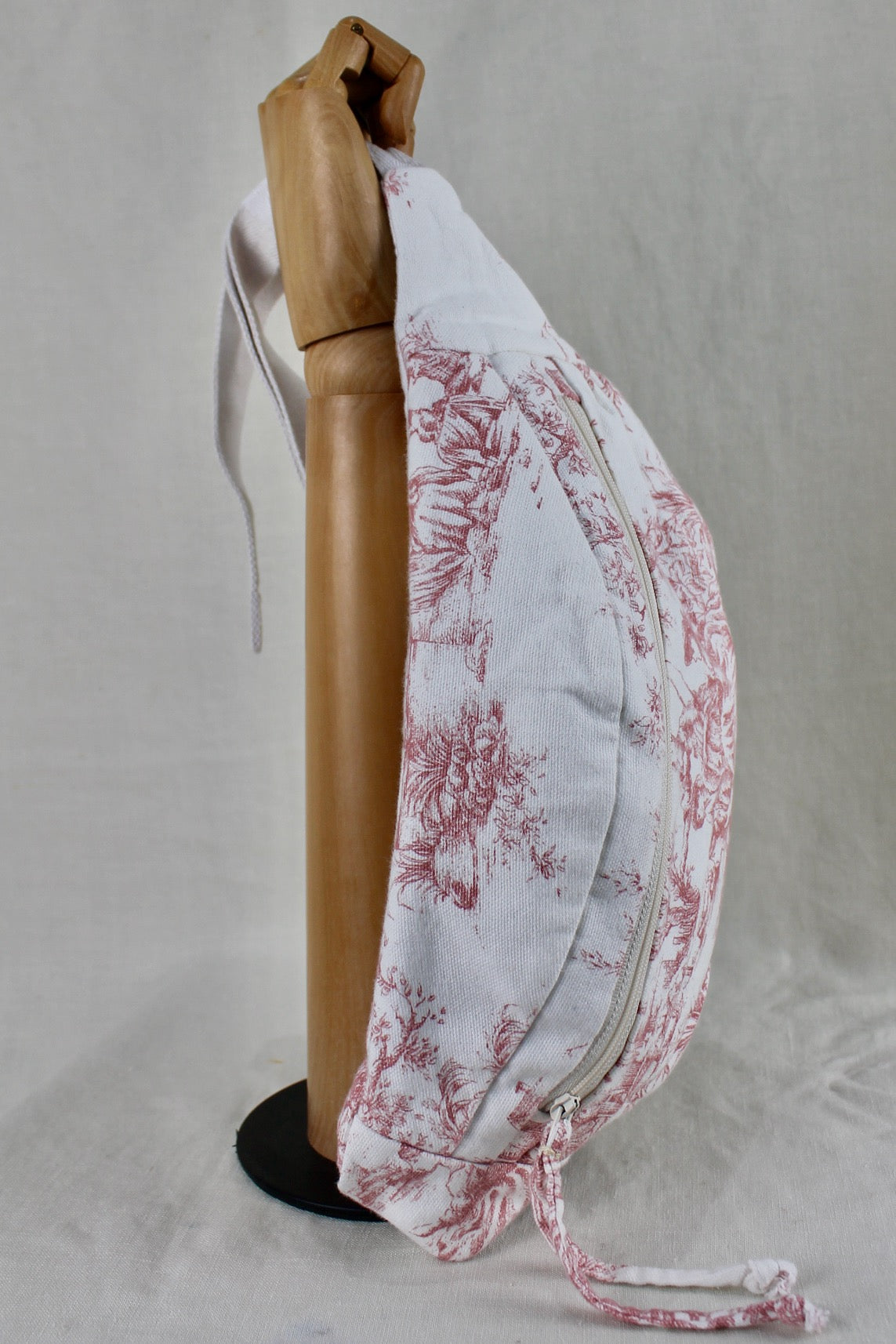 Top view of one-of-a-kind bumbag made from pink and white toile du jouy vintage textile