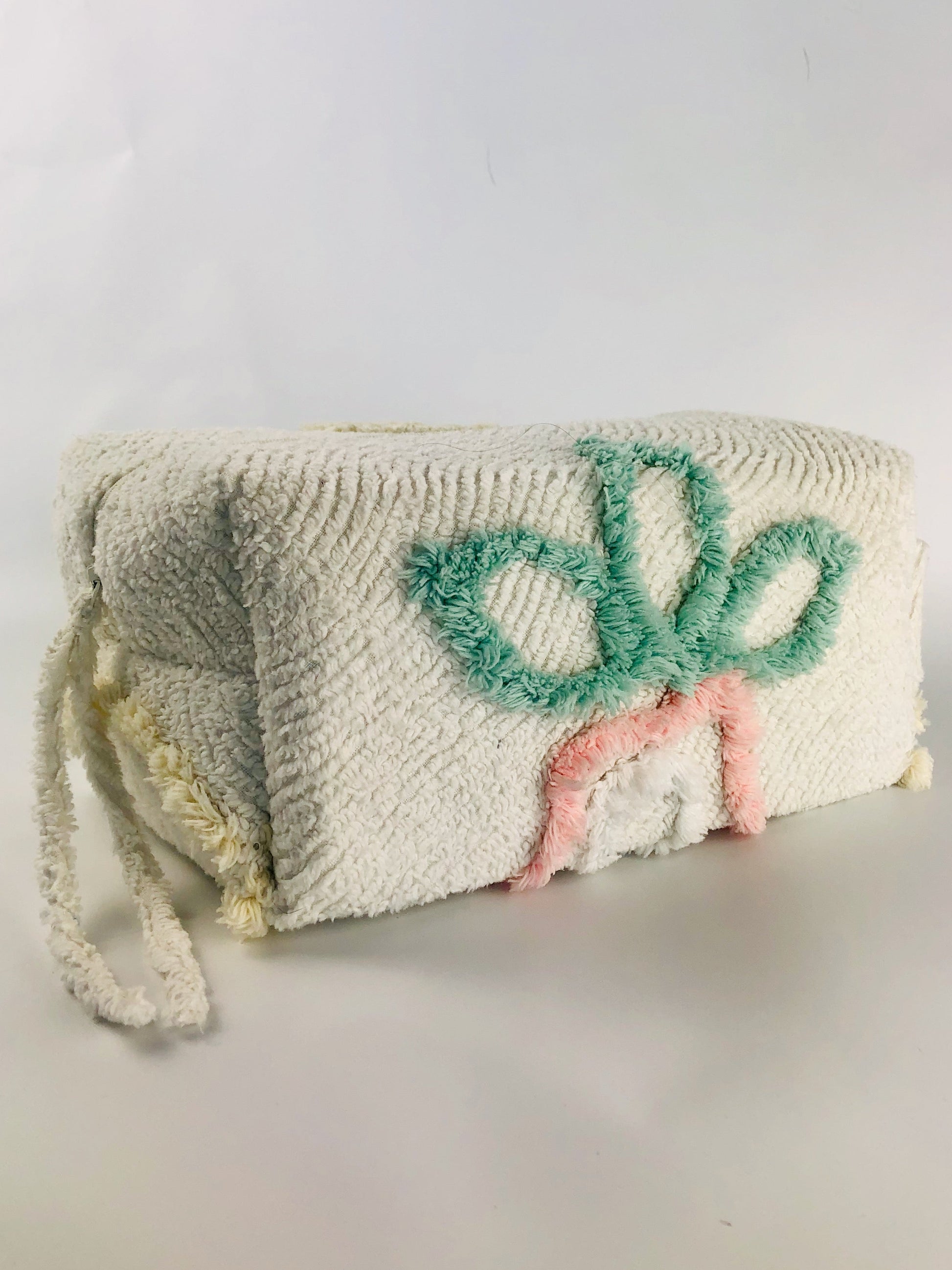 Side view of ethically made chenille make up and cosmetics bag