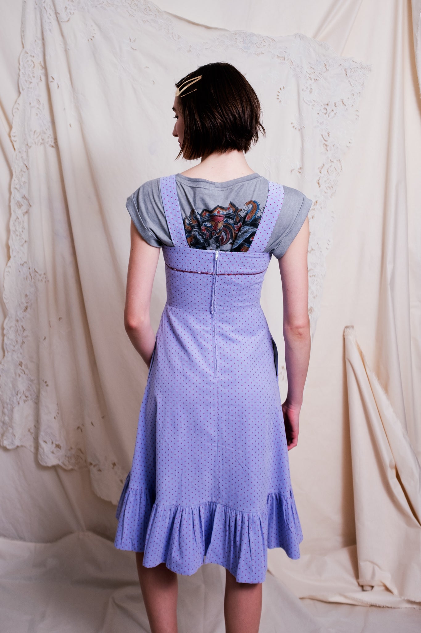 Back view of corduroy dress in lilac with tiny maroon flecked spots