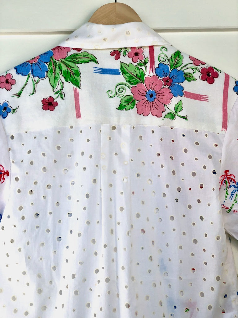 Close up detail of back view of handmade shirt in white, pink, blue and green