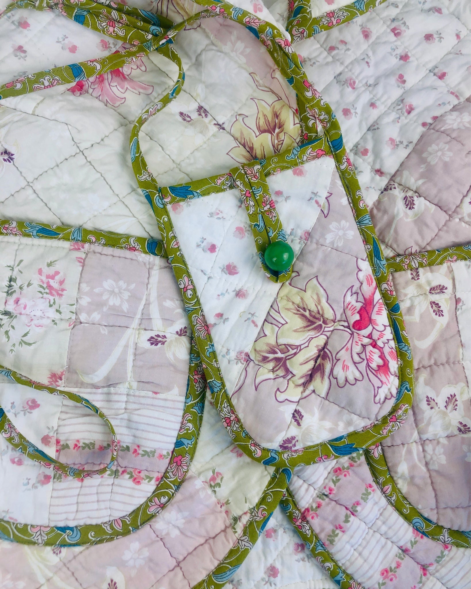 Phone pocket made from workroom offcuts of a vintage quilt finished with liberty of london bias binding