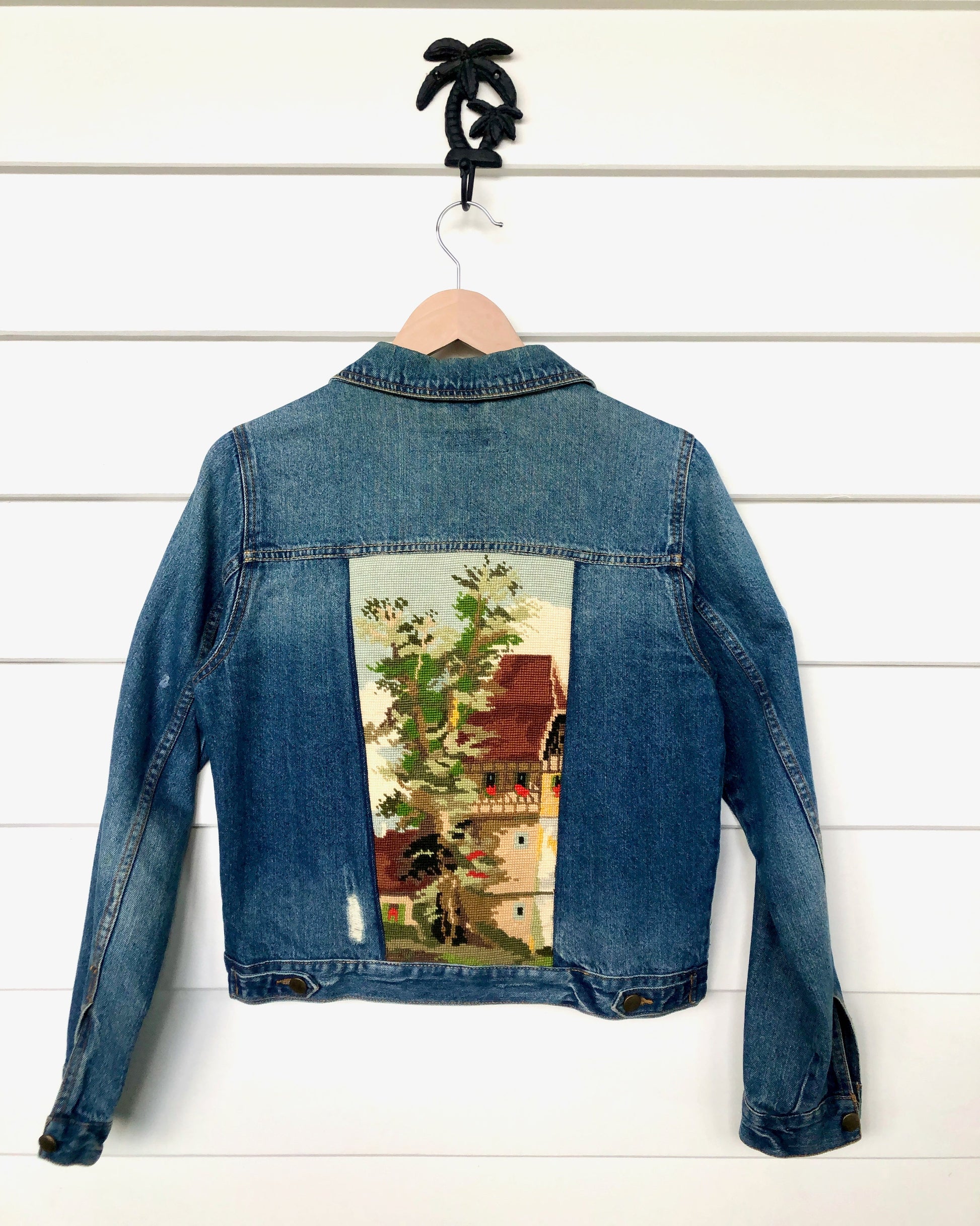 Up cycled denim jacket with a handmade embroidery on the back panel
